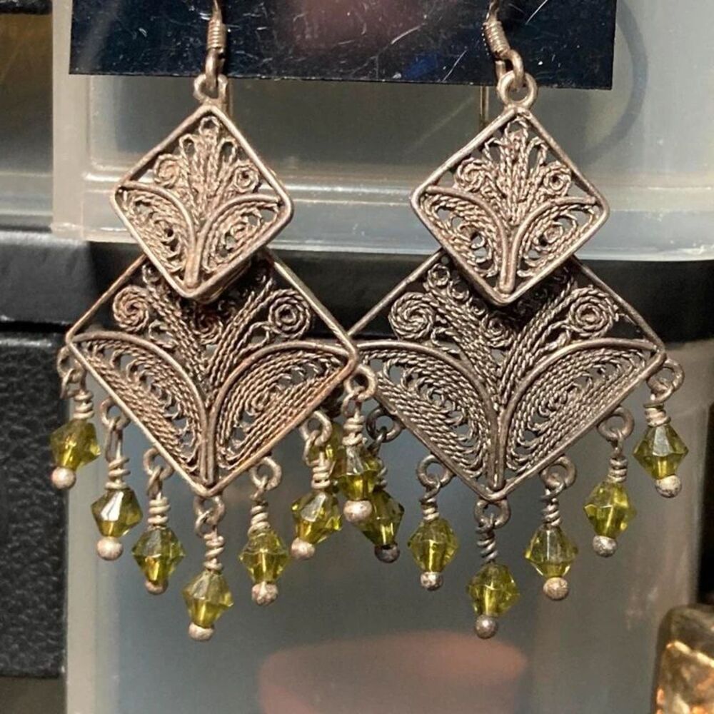 Silver earrings with green beads and filigree design